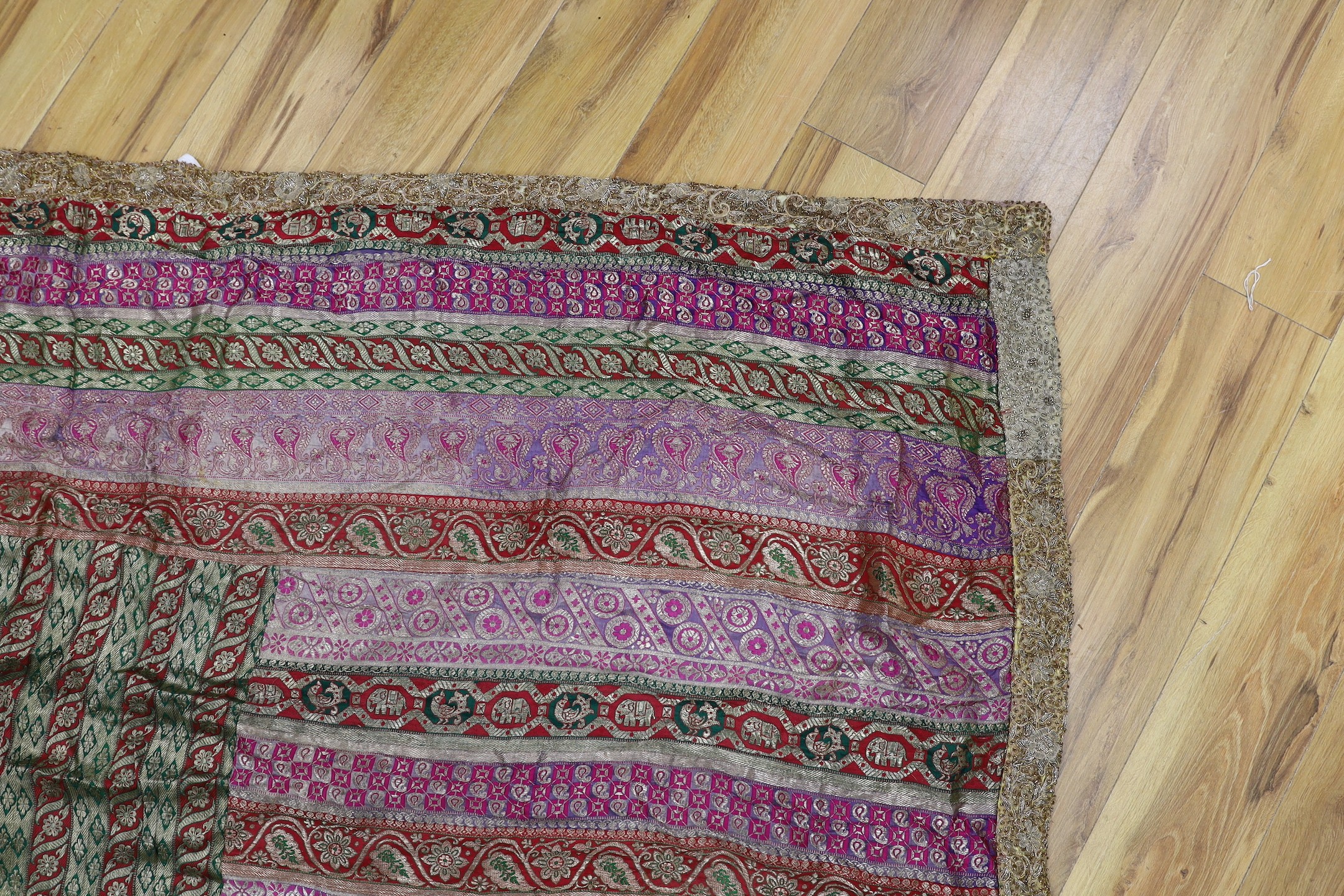 A French 18th century woolwork cushion, 2 chair covers, another panel, a tasselled brocade cushion and an Indian metallic brocaded patchworked cover